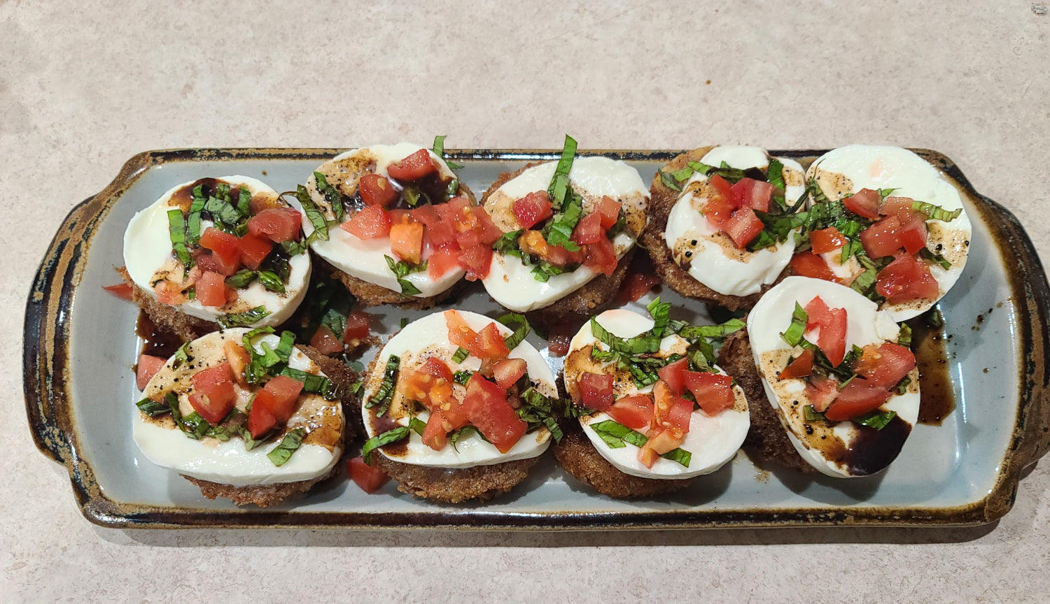 fried green tomato topped with mozzarella marinated tomato